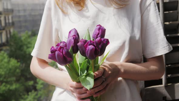 Bouquet of Flowers Purple Tulips in Woman Hands alt