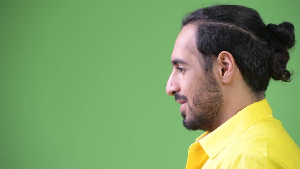 Profile View of Young Happy Bearded Indian Businessman Smiling alt