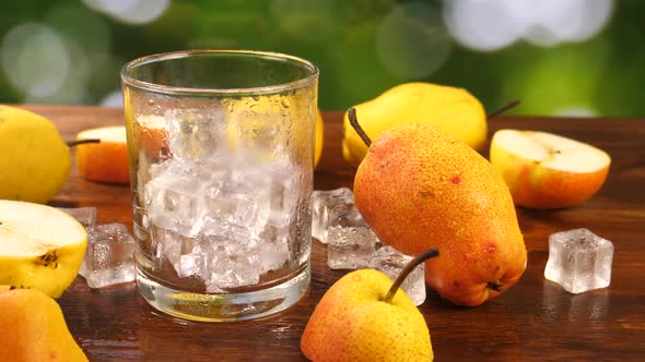 Pear Juice Poured in Glass with Ice Cubes