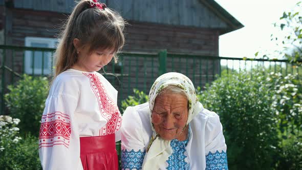 An Old Grandmother is Sitting on the Street and Reading a Book alt
