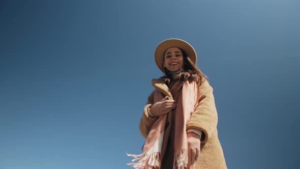 The Girl Enters the Frame Against the Blue Sky alt