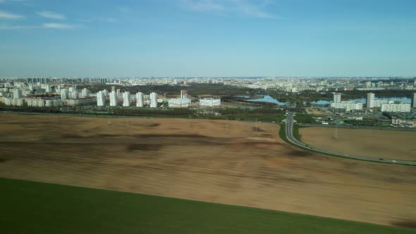 Spring agricultural land. A plowed and cultivated field borders on an uncultivated area overgrown wi alt