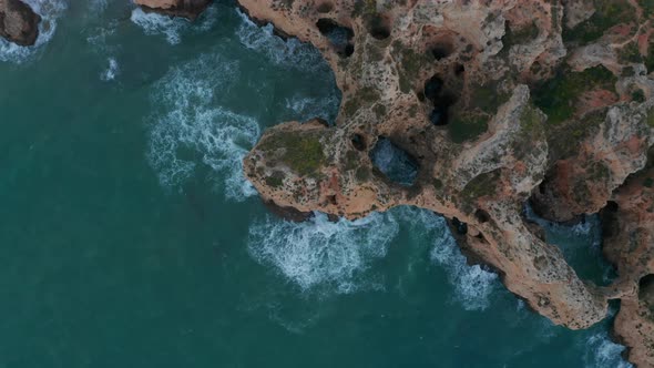 Aerial Birds Eye Overhead Top Down View of Scenic Lagos Colored Rocky Cliff Coast in Lagos Algarve alt