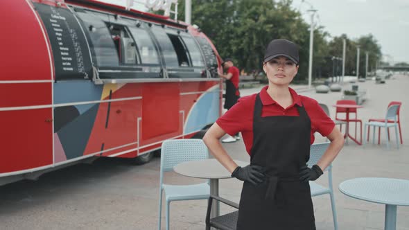 Portrait of Female Seller of Street Food from Truck alt
