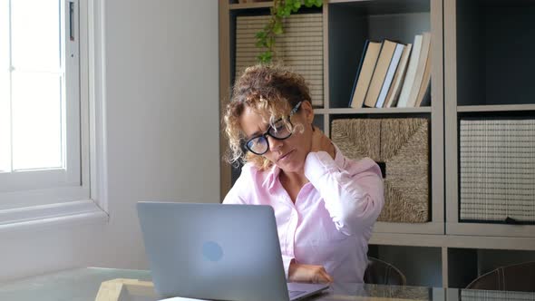 Tired young woman touch stiff neck feeling hurt joint back pain rubbing massaging tensed muscles alt