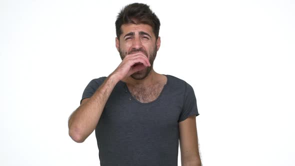 Slomo Picture of Handsome Young Man in Grey Tshirt Looking at Camera Yawning Covering Mouth with alt