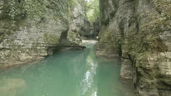 Aerial view of Martvili canyon. Blue water in fresh cold mountain river at sunny summer morning alt