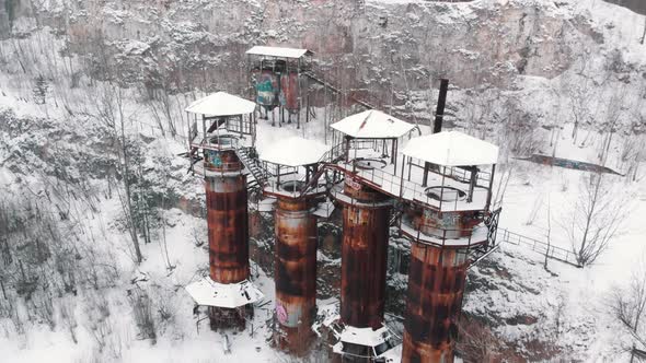 Aerial Footage of Old Machines and Piping Equipment in Liban Quarry  Snow Fall alt