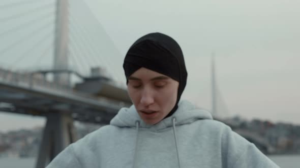 Arabian Woman in Hijab Resting After Outdoors Cardio alt