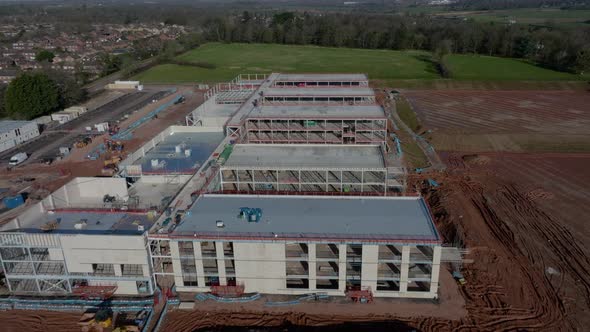 New School Construction Building Site UK Large Steel Frame Aerial View Fly Over alt