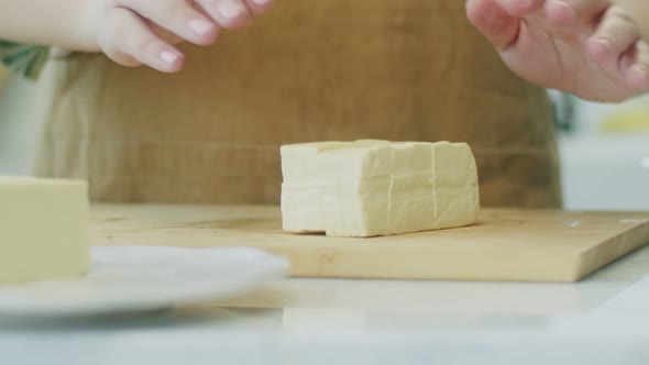 Woman preparing cheese for cooking meal alt