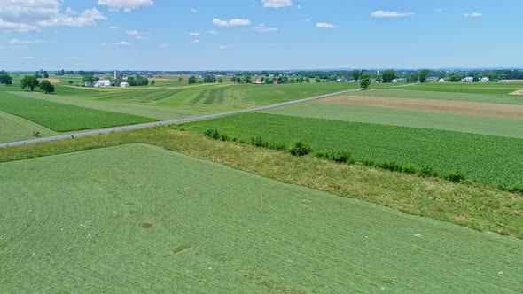 Aerial View of the Farm Countryside with Planted Fields and Pastures alt