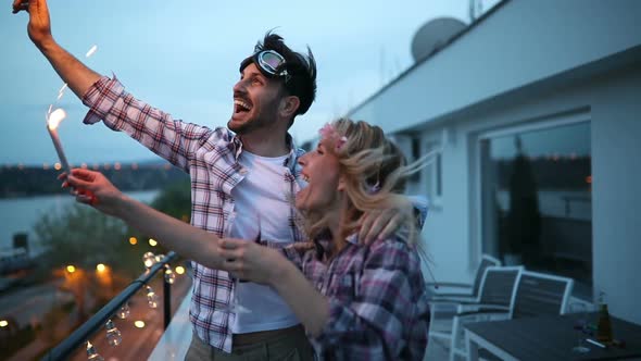 Happy Couple Having Fun and Partying on Balcony