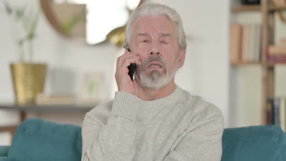 Old Man Talking on Smartphone alt