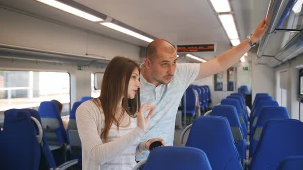 Young Couple Riding in a Suburban Train