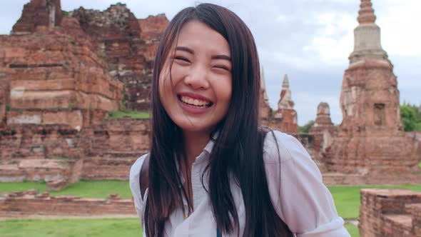 Asian backpacker blogger woman casual with camera take photo smiling traveling.