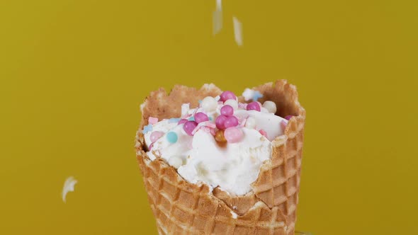 Decorating Ice Cream with Colored Balls. Confectionery, Sprinkle Ice Cream with Crumbs, Close-up.