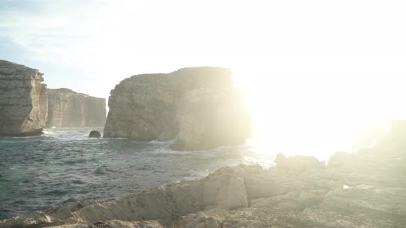 Golden Sun Rays Painting Fungus Rock Limestone Islet in the Maltese Archipelago
