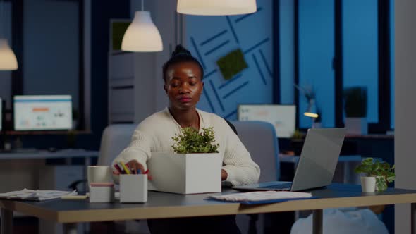 Sad African Fired Businesswoman Packing Things in Box Being Dismissed From Job alt