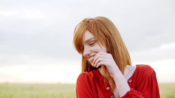 Close Up of Redhead Woman Face Smiling Romantic Looking Away with Happy Carefree Emotion