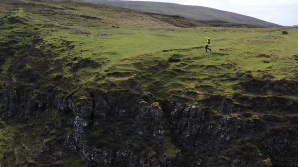 Man adventurer with backpack exploring Isle of Skye