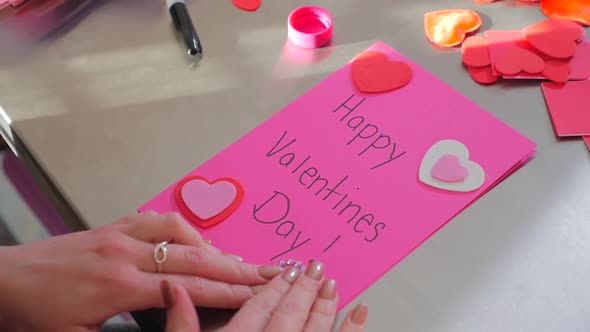 A Female Creating A Happy Valentines Day Card With Red Hearts 2