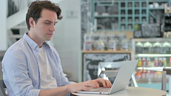 No Gesture with Finger By Young Man in Cafe alt