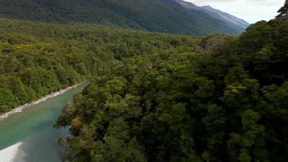 Aerial view of green river in a mountain valley. Fast flowing river in Blue Pools in New Zealand alt