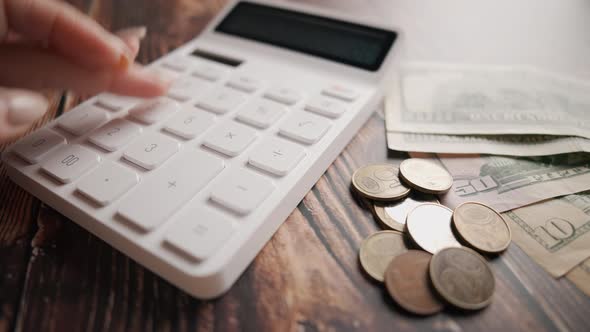 A Woman is Calculating Her Expenses for a Month alt