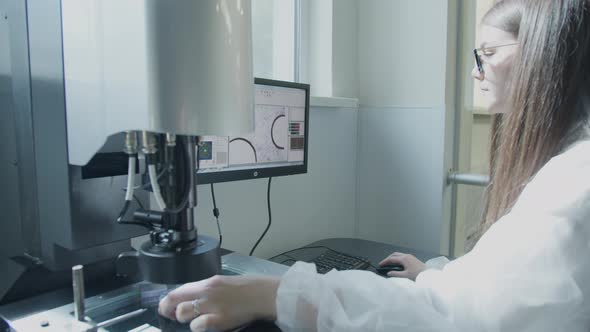 Scientist Working with Microscope in Manufacturing Laboratory