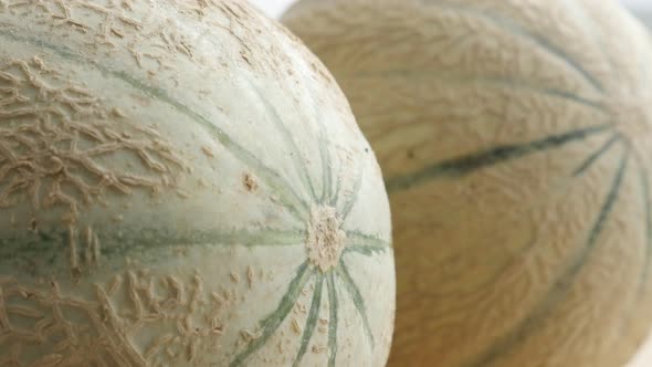 Pair fresh melons concept  food background  tilting 4K 2160p 30fps UltraHD footage - Slow tilt on  C alt