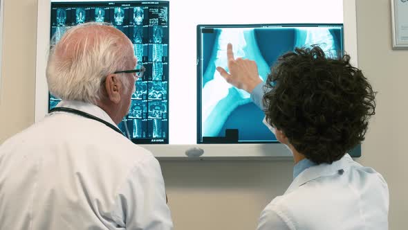 Two doctors examining X-ray pictures