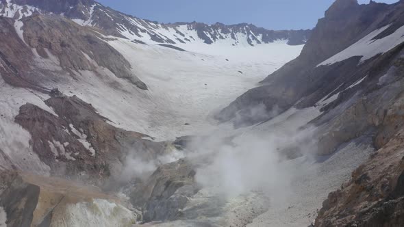 Aerial Drone Footage of Mutnovsky Volcano Crater with Fumaroles and Glacier