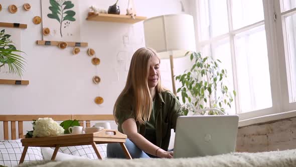 A Young Freelance Woman Who Has a Video Call with a Colleague Working Online From Home in a Cozy alt
