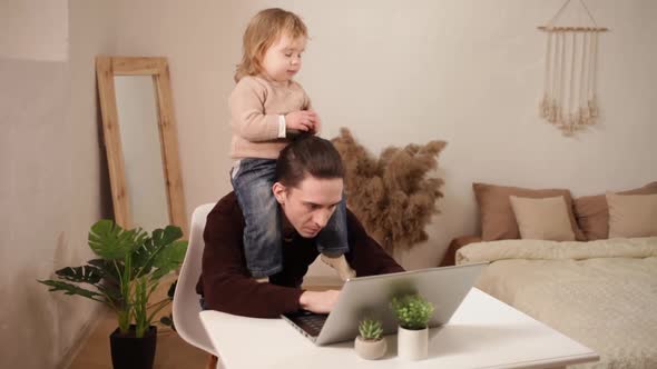 A Man Tries to Work Behind a Laptop at Home alt