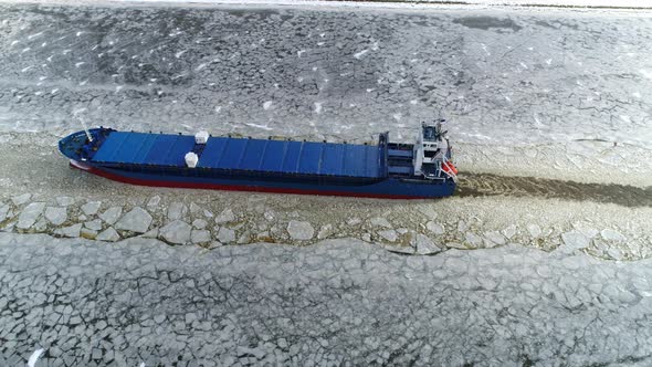 Aerial Shot of Cargo Ship Braking Ice  alt