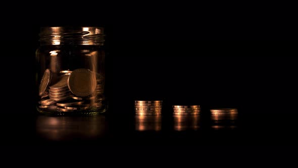 Stop motion of Stack of golden coins in bar chart form on black background alt