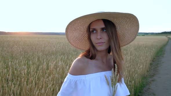 Amazing Portrait of Beautiful Woman Standing in Field of Ripe Golden Wheat alt