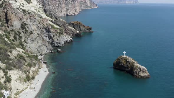 Aerial view of rocky coast and blue sea alt