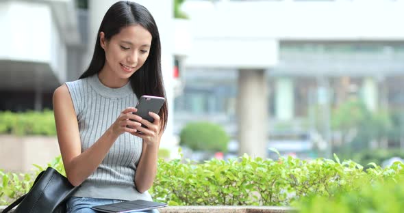 Woman Using Smart Phone in Street alt