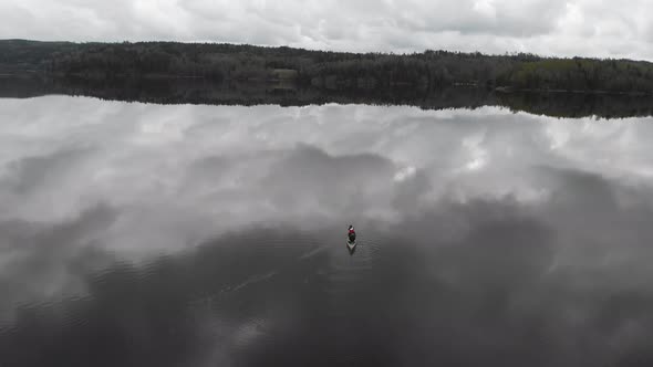 Alone Canoeing Lake With Overcast Clouds Reflection Nature Horizon Aerial