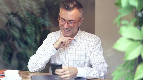 Smiling man in the coffee shop.