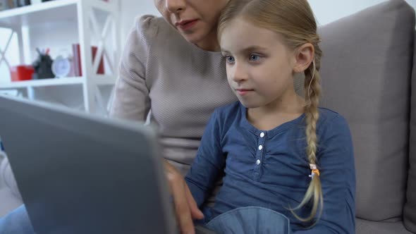 Little Girl and Mother Making Videocall on Tablet Pc, Waving Hands on Camera