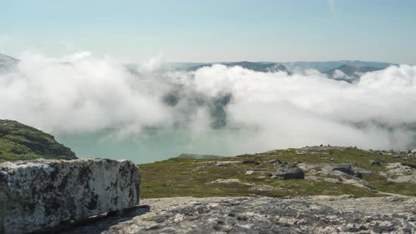 Slider time lapse of fogement above mountain lake, Norway alt