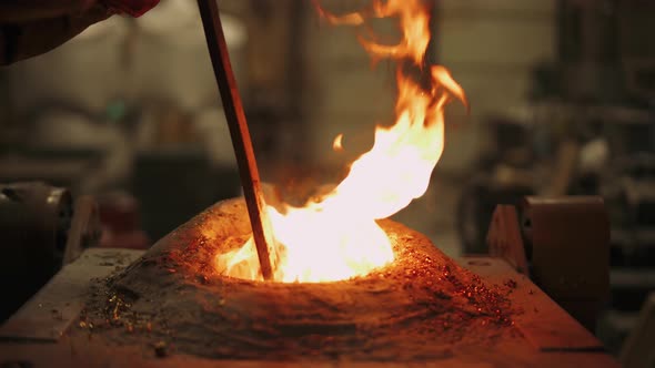 Foundry, Steel Industry, Worker Mixes Liquid Metal in Furnace, Flame, Remelting Steel alt
