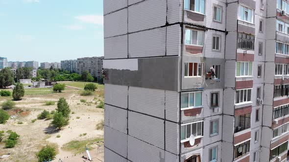 Industrial Climber Painting Building Facade Wall, Insulation Work, Aerial View alt
