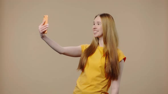 Portrait of Model with Natural Beauty is Talking on a Video Call Using a Smartphone alt