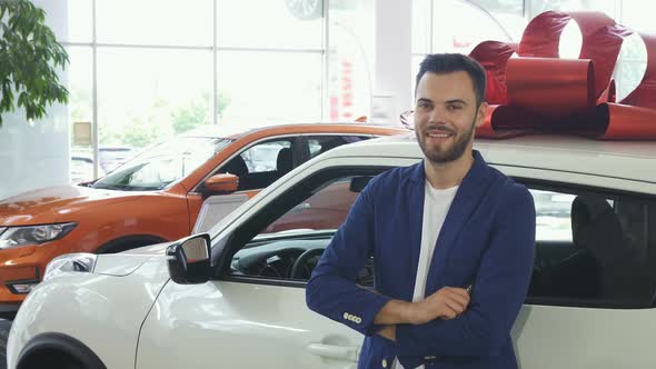 Young Happy Man Smiling Showing Car Keys To His New Automobile alt