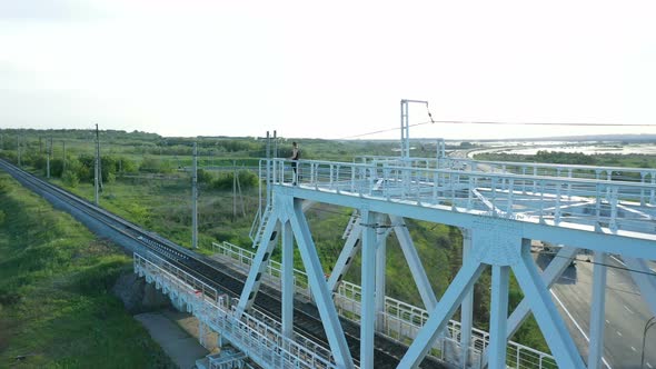 Man Standing on Top of Railway Bridge