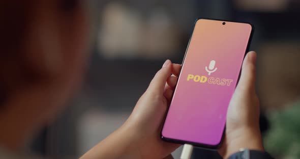 Asia lady wear headphones using phone listen digital music podcast online channel sit on sofa. alt